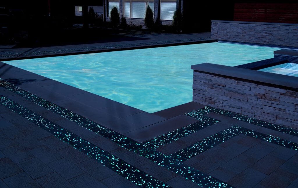 Swimming pool rendering showing off GlowPath Pavers at night
